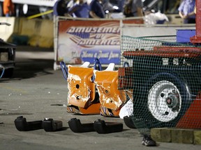 Authorities stand near damaged chairs of the Fire Ball amusement ride after the ride malfunctioned injuring several at the Ohio State Fair, Wednesday, July 26, 2017, in Columbus, Ohio. Some of the victims were thrown from the ride when it malfunctioned Wednesday night, said Columbus Fire Battalion Chief Steve Martin.