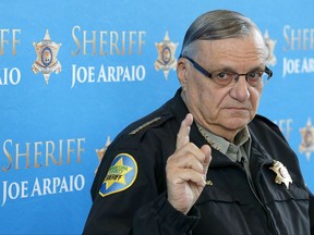 FILE - In this Dec. 18, 2013 file photo, Maricopa County Sheriff Joe Arpaio pauses as he answers a question at a news conference at Maricopa County Sheriff's Office Headquarters in Phoenix. Lawyers are scheduled to make closing arguments Thursday, July 6, 2017, at the criminal trial of the former six-term sheriff of metro Phoenix. Arpaio is charged with misdemeanor contempt-of-court for defying a judge's order to stop his traffic patrols that targeted immigrants. (AP Photo/Ross D. Franklin, File)