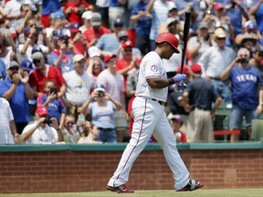 Fans stand and watch as Texas Rangers' Adrian Beltre walks up to the plate for his at-bat in the second inning of a baseball game against the Baltimore Orioles on Sunday, July 30, 2017, in Arlington, Texas. Belter struck out in the at-bat in his chase for his 3,000th career hit. (AP Photo/Tony Gutierrez)