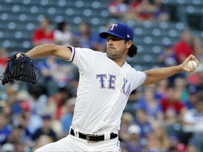 Texas Rangers' Cole Hamels throws to the Seattle Mariners in the second inning of a baseball game, Monday, July 31, 2017, in Arlington, Texas. (AP Photo/Tony Gutierrez)