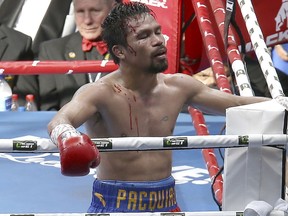 In this Sunday, July 2, 2017, file photo, Manny Pacquiao of the Philippines reacts after his loss to Jeff Horn of Australia, during their WBO World Welterweight title fight in Brisbane, Australia. (AP Photo/Tertius Pickard, File)