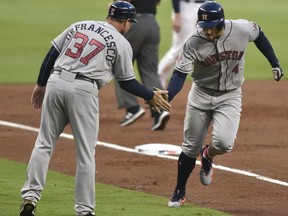 Houston Astros' George Springer celebrates a run with Astros Triple-A manager Tony DeFrancesco during the third inning of a baseball game against the Atlanta Braves, Tuesday, July 4, 2017, in Atlanta. (AP Photo/Richard Hamm)