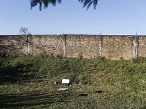 A chair sits in a high-walled outdoor area of La Esperanza Integral Education Center, a correctional center for juveniles, in Itaugua, Paraguay, Friday, July 14, 2017. La Esperanza is a semi-open system, located about 16 miles or 26 kilometers from Asunción. Inmates who are on good behavior can participate in a workshop where they can learn to make stringed instruments from master luthiers. (AP Photo/Jorge Saenz)