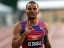 In this July 7 file photo, Andre De Grasse gestures to the crowd after winning gold in the men's 100m at the national championships in Ottawa.