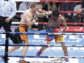 Jeff Horn of Australia, left, and Manny Pacquiao of the Philippines, right, lands a left to during their WBO World Welterweight title fight in Brisbane, Australia, Sunday, July 2, 2017.  Pacquiao lost his WBO welterweight world title to Horn in a stunning, unanimous points decision in a Sunday afternoon bout billed as the Battle of Brisbane in front of more than 50,000 people.(AP Photo/Tertius Pickard)