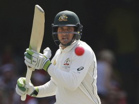 FILE - In this Dec. 17, 2016 file photo, Australia's Usman Khawaja plays a shot during play on day three of the first cricket test between Australia and Pakistan in Brisbane, Australia. Australian cricketers have canceled a tour to South Africa in the first boycott of their ongoing pay dispute with the sport's national governing body. The Australian Cricketers' Association announced Thursday, July 6, 2017 that the Australia A tour will not go ahead. (AP Photo/Tertius Pickard, File)