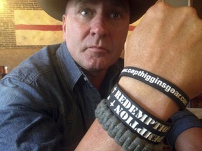 FILE- In this June 2, 2016, file photo, Clay Higgins, a former Captain for the St. Landry Parish Sheriff's office, and candidate for Congress, poses for a photograph in Lafayette, La. The Louisiana congressman is apologizing for the "unintended pain" caused by a video of his visit to a gas chamber at a Nazi concentration camp. Higgins said in an email Wednesday that he's retracting the video, recorded at the Auschwitz camp in Poland that is now part of the Auschwitz-Birkenau Memorial and Museum. (AP Photo/Kevin McGill, File)