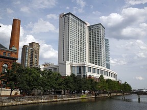 This June 29, 2017 photo shows the Marriott Hotel in Baltimore's Harbor East district. In sales brochures, a U.S. company boasted of the "stunning visual effect" its shimmering aluminum panels created in an NFL stadium, an Alaskan school and a 33-story hotel on Baltimore's waterfront.  Those same panels also were used in London's Grenfell Tower. British authorities are examining whether the panels helped spread the fire that ripped across the apartment building's outer walls, killing at least 80 people. (AP Photo/Patrick Semansky)