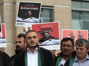 Turkish lawyers hold a protest outside Istanbul's court, Monday, July 17, 2017, demanding the release of Mustafa Yaman, a lawyer who according to Turkish media was detained earlier this month on suspicion of links to U.S.-based Muslim cleric Fethullah Gulen, accused by Turkey of masterminding last year's failed coup. Turkey has arrested more than 50,000 people in a large-scale crackdown launched after the failed coup attempt. (AP Photo/Lefteris Pitarakis)