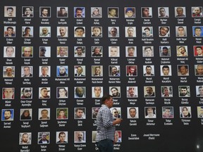 A man walk past a poster of photographs of victims of the July 15, 2016 coup attempt, in Istanbul, Friday July 14, 2017. Turkey commemorates the first anniversary of the July 15 failed military attempt to overthrow Turkey's President Recep Tayyip Erdogan, with a series of events honoring some 250 people, who were killed across Turkey while trying to oppose coup-plotters. (AP Photo/Lefteris Pitarakis)