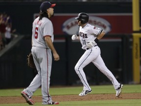 Arizona Diamondbacks' A.J. Pollock (11) rounds the bases after hitting a solo home run as Washington Nationals Anthony Rendon (6) stands nearby during the first inning of a baseball game, Friday, July 21, 2017, in Phoenix. (AP Photo/Matt York)