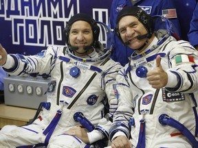 U.S. astronaut Randy Bresnik , left, and Italian astronaut Paolo Nespoli members of the main crew of the expedition to the International Space Station (ISS), gesture prior the launch of Soyuz MS-05 space ship at the Russian leased Baikonur cosmodrome, Kazakhstan, Friday, July 28, 2017. (AP Photo/Dmitri Lovetsky)