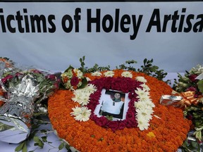 Floral offerings lie in remembrance of victims of the attack on Holey Artisan Bakery, on the first anniversary of the deadly hostage crisis at the upscale Dhaka restaurant in Bangladesh, Saturday, July 1, 2017. The Bangladesh cafe was besieged by militants who tortured and killed 20 hostages last year. (AP Photo/ A.M. Ahad)