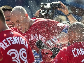 Toronto Blue Jays LF Steve Pearce is mobbed by teammates after hitting a walk-off grand slam on July 30.