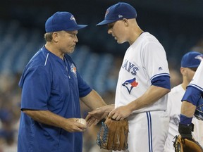 Blue Jays manager John Gibbons, left, takes starting pitcher Aaron Sanchez out of their game against the Houston Astros after giving up six runs in the second inning in Toronto on Friday night.