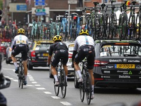 Britain's Chris Froome, his pants torn after crashing, right, follows teammates to catch up with the pack during the second stage of the Tour de France cycling race over 203.5 kilometers (126.5 miles) with start in Dusseldorf, Germany, and finish in Liege, Belgium, Sunday, July 2, 2017. (AP Photo/Peter Dejong)