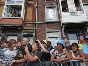 Spectators watch the riders prior to the start of the third stage of the Tour de France cycling race over 212.5 kilometers (132 miles) with start in Verviers, Belgium and finish in Longwy, France, Monday, July 3, 2017. (AP Photo/Christophe Ena)