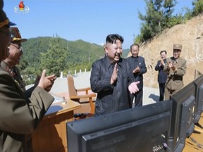 This image made from video of a news bulletin aired by North Korea's KRT on Tuesday, July 4, 2017, shows what was said to be North Korea leader Kim Jung Un, center, applauding after the launch of a Hwasong-14 intercontinental ballistic missile (ICBM) in North Korea's northwest. Kim Jong Un has something his father and grandfather could only dream of, an intercontinental ballistic missile capable of striking the United States with a nuclear weapon. Independent journalists were not given access to cover the event depicted in this photo. (KRT via AP Video, File)