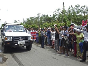 Demonstrators in the western state of Rakhine hold up protest signs as the motorcade of Yanghee Lee, U.N. Special Rapporteur on Human Rights, passes through, Wednesday, July 12, 2017, in Sittwe, Myanmar. United Nations's human rights envoy in Myanmar on Wednesday begins the sixth information-gathering visit to the country's west, in the tense Rakhine state, where security forces are accused of violating human rights against Muslim Rohingya minority. (AP Photo/Min Thein Khine)