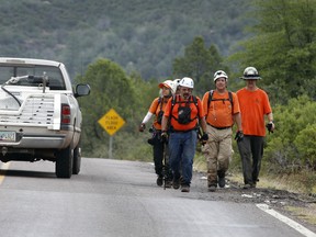 Members of the Tonto Rim search and rescue team searching for victims after Sunday's flash flood. Authorities did not identify the dead, but relatives listed the names to local media.