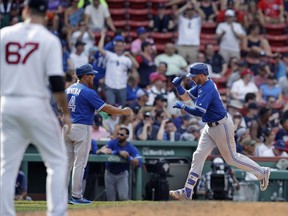 Toronto Blue Jays 1B Justin Smoak (right) celebrates his second home run against the Boston Red Sox on July 20.