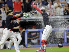 Cleveland Indians' Giovanny Urshela douses teammate Francisco Lindor after Lindor hit a solo home run in the 10th inning of game against the Toronto Blue Jays on Saturday.