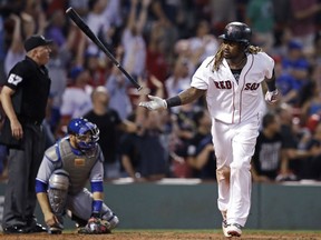 Hanley Ramirez of the Red Sox flips his bat after his game-winning solo home run during the 15th inning against the Toronto Blue Jays at Fenway Park in Boston on Tuesday night. The Red Sox won 5-4.