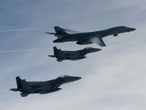 A U.S. Air Force B-1B Lancer bomber (top) flies with South Korean jets over the Korean Peninsula during a South Korea-U.S. joint live fire drill on July 8, 2017 in Korean Peninsula, South Korea.