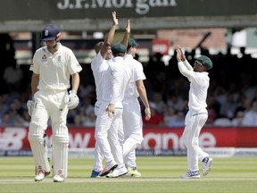 South Africa's Vernon Philander, second left, celebrates taking the wicket of England's Alastair Cook, left, during the first test between England and South Africa at Lord's cricket ground in London, Thursday, July 6, 2017. (AP Photo/Matt Dunham)