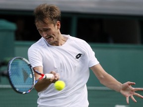 Russia's Daniil Medvedev returns to Switzerland's Stan Wawrinka during his Men's Singles Match on the opening day at the Wimbledon Tennis Championships in London Monday, July 3, 2017. (AP Photo/Kirsty Wigglesworth)