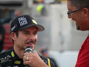 In this June 18, 2016 file photo, Alex Tagliani (left) is interviewed at Sunset International Speedway in Innisfil, Ont.