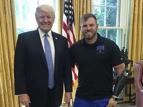 In this photo provided by the Travis Mills Foundation, President Donald Trump poses with Travis Mills in the Oval Office at the White House in Washington. Mills, an Army veteran who lost all four limbs in an explosion in Afghanistan, opened a retreat in Rome, Maine, in June for other injured veterans. Mills said he was meeting with with Vice President Mike Pence about his veterans retreat when he got a chance to meet the president, too. (Travis Mills Foundation via AP)