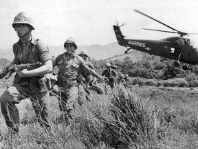 U.S. Marine infantry stream into a suspected Viet Cong village near Da Nang in Vietnam during the Vietnamese war.