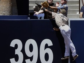 San Diego Padres center fielder Manuel Margot leaps at the fence but cannot catch a solo home run by Pittsburgh Pirates' Andrew McCutchen during the first inning of a baseball game in San Diego, Sunday, July 30, 2017. (AP Photo/Alex Gallardo)