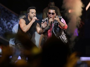 FILE - In this April 27, 2017 file photo, singers Luis Fonsi, left and Daddy Yankee perform during the Latin Billboard Awards in Coral Gables, Fla. Universal Music Latin Entertainment announced Wednesday, July 19, 2017, that "Despacito" has become the most streamed song of all time with more than 4.6 billion plays six months after its release. The song by Luis Fonsi and Daddy Yankee, and a companion remix featuring Justin Bieber, has surpassed the 4.38 billion plays recorded for the previous record holder, which was Bieber's hit "Sorry." (AP Photo/Lynne Sladky, File)