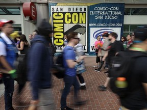 People arrive for the first day of Comic-Con Thursday, July 20, 2017, in San Diego. Comic-Con, which started as a comic-book convention with 300 participants in 1970 and has grown into a corporate-heavy media showcase that draws more than 130,000 attendees, runs through Sunday in San Diego. (AP Photo/Gregory Bull)