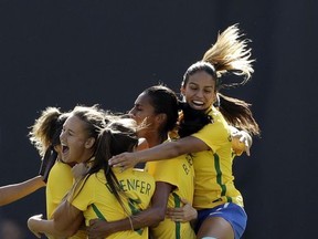 Brazil's team celebrates after midfielder Debinha scored against the United States during the first half of a Tournament of Nations women's soccer match Sunday, July 30, 2017, in San Diego. (AP Photo/Gregory Bull)