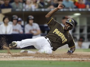 San Diego Padres' Jabari Blash scores on a single by Erick Aybar during the second inning of the team's baseball game against the San Francisco Giants on Friday, July 14, 2017, in San Diego. (AP Photo/Gregory Bull)