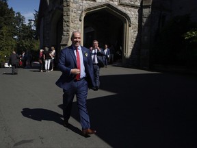 Premier John Horgan leaves Government House after being sworn-in as Premier in Victoria, B.C., on Tuesday, July 18, 2017. THE CANADIAN PRESS/Chad Hipolito