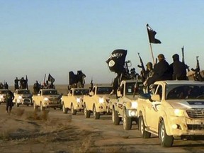 FILE - In this undated file photo released online in the summer of 2014 on a militant social media account, which has been verified and is consistent with other AP reporting, militants of the Islamic State group hold up their weapons and wave its flags on their vehicles in a convoy on a road leading to Iraq, in Raqqa, Syria. The Islamic State group's mashup of local insurgency and digitally-connected global jihadis gives the group staying power and a launchpad for its future. The impending loss of Mosul and Raqqa will still urban heart of its self-proclaimed Caliphate, but the extremist organization has built-in plans to endure, a blueprint for supporters and the flexibility to bide its time away from airstrikes. (Militant photo via AP, File)