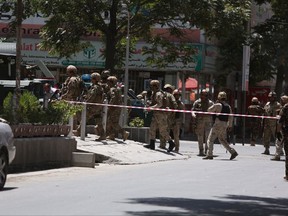 Afghan security forces arrive at the site of complex attack in Kabul, Afghanistan, Monday, July 31, 2017. Afghan police say a car bombing has targeted the Iraqi Embassy in central Kabul, followed by gunfire, and that the attack is still underway. (AP Photo/ Rahmat Gul)