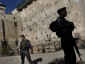 Israeli border police stand guard on the site known to Jews as the Tomb of the Patriarchs, and to Muslims as the Ibrahimi Mosque, in the West Bank city of Hebron.