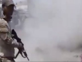 This photo made from undated video posted online in July, 2017 shows a man in an Iraqi Army uniform, moments after shooting an unarmed man in Mosul, Iraq.