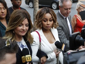 Blac Chyna, center, and her attorney Lisa Bloom, left, arrive for a hearing seeking a restraining order against her former fiancee Rob Kardashian on Monday, July 10, 2017, in Los Angeles. Chyna has accused Kardashian of cyber bullying and domestic violence over a series of lurid Instagram posts he made last week. The posts got Kardashian's Instagram account shut down, but he continued his attacks on Twitter. (AP Photo/Jae C. Hong)