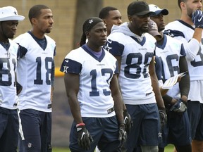 Dallas Cowboys wide receiver Lucky Whitehead (13) stands with fellow receivers during practice at the NFL football team's training camp in Oxnard, Calif., Monday, July 24, 2017. (AP Photo/Michael Owen Baker)