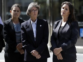 From left, Oakland city officials including city administrator Sabrina Landreth, police chief Anne Kirkpatrick, and Mayor Libby Schaaf wait to talk to the media after a federal court hearing, Monday, July 10, 2017, in San Francisco. Civil rights lawyers say a federal judge should consider holding Oakland, California, city and police officials in contempt of court for mishandling an internal affairs investigation of several officers alleged to have sexually exploited an underage prostitute. (AP Photo/Marcio Jose Sanchez)