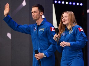 Canada's newest astronauts Joshua Kutryk and Jennifer Sidey acknowledge the crowd during Canada 150 celebrations on Parliament Hill in Ottawa on Saturday, July 1, 2017.