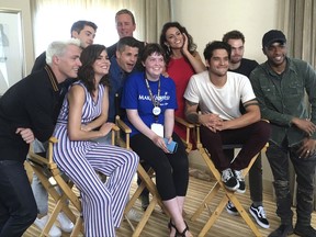 Sydney Lang, 16, of Edmonton, Alberta, seated center, poses with cast members from "Teen Wolf" during a meet-and-greet arranged by the Make-A-Wish Foundation on day two of Comic-Con International on Friday, July 21, 2017, in San Diego. Pictured from front row left, Colton Haynes, Shelley Hennig, Charlie Carver, Tyler Posey and Khylin Rhambo, and from back row left are Cody Christian, Linden Ashby, Melissa Ponzio, and Dylan Sprayberry. (AP Photo/Sandy Cohen)