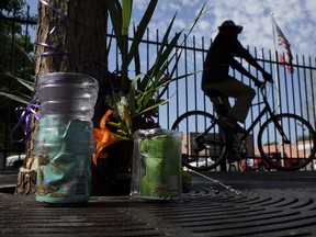 A makeshift memorial is placed near the scene of an accident Wednesday, July 5, 2017, where a woman, the day before, plowed her vehicle into six people in Salt Lake City. Police searched Wednesday for the woman who drove onto a sidewalk near a Salt Lake City homeless shelter, killing one woman and injuring five others (Francisco Kjolseth/The Salt Lake Tribune via AP)