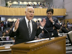 California Gov. Jerry Brown, left, flanked by Senate President Pro Tem Kevin de Leon, D-Los Angeles, urges members of the Senate Environmental Quality Committee to approve a pair of bills to extend state's cap and trade program, Thursday, July 13, 2017, in Sacramento, Calif. (AP Photo/Rich Pedroncelli)
